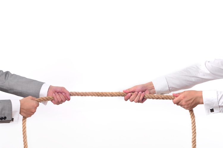 Tug war, two businessman pulling a rope in opposite directions isolated on white background